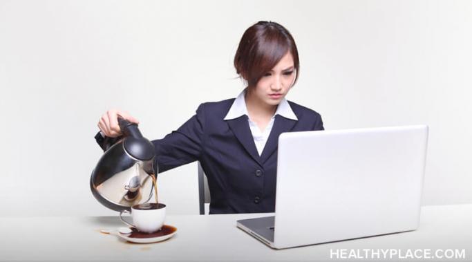一个女人看着电脑屏幕往杯子里倒咖啡